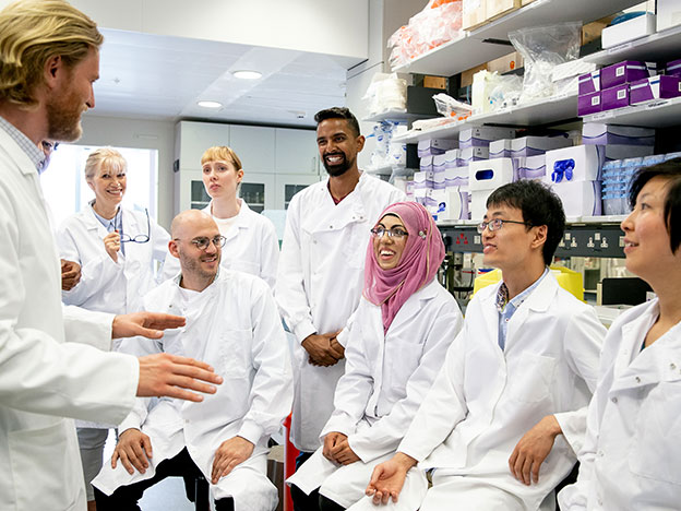 Smiling colleagues in lab coats